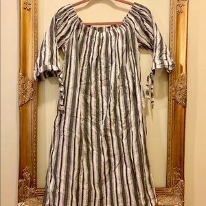 black, cream, and beige dress with ties on sleeves